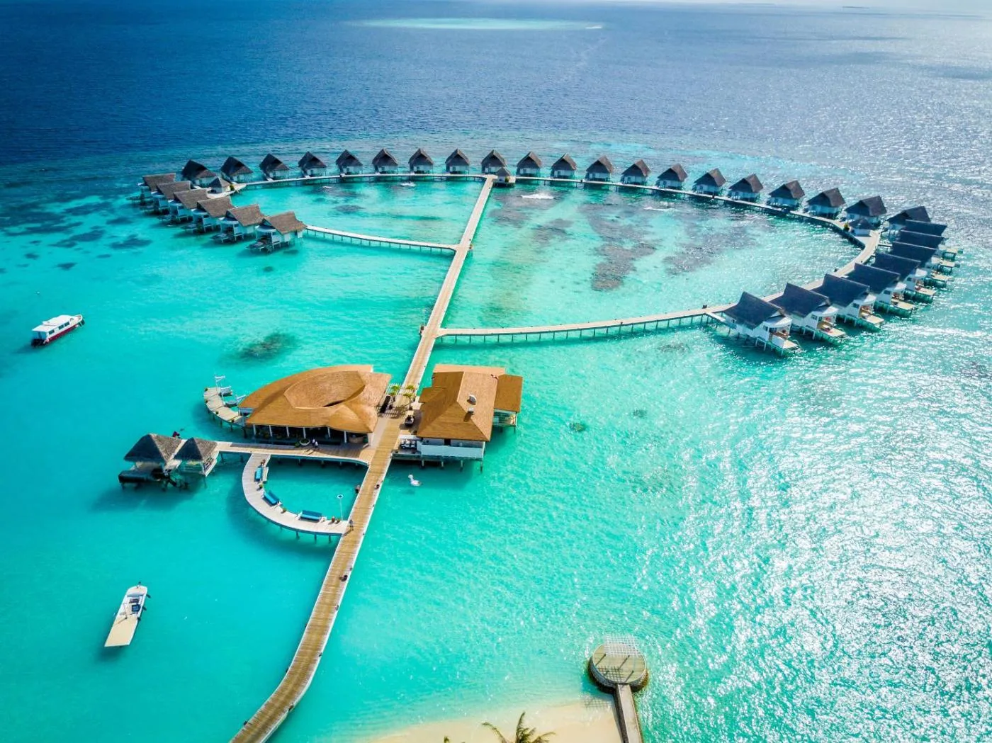Crystal-clear water bungalows in the Maldives, with hammocks and clear skies